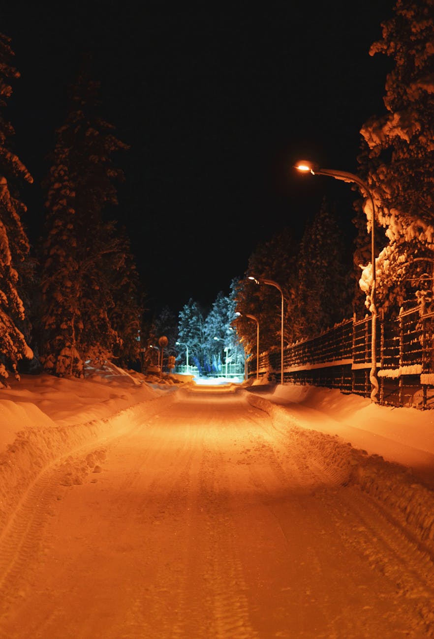 night winter road with light in end